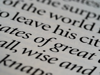 Close-up of classic serif typography on warm, muted parchment with a faint horse motif.