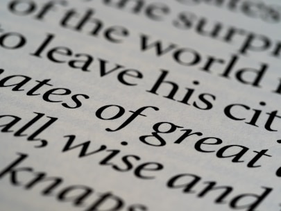Close-up of elegant serif typography on a dark textured background with subtle gold highlights.