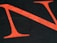 A large red letter N is overlaid on a black background, with small typed text visible within the letter. The text provides a textured appearance, and the color contrast is striking.