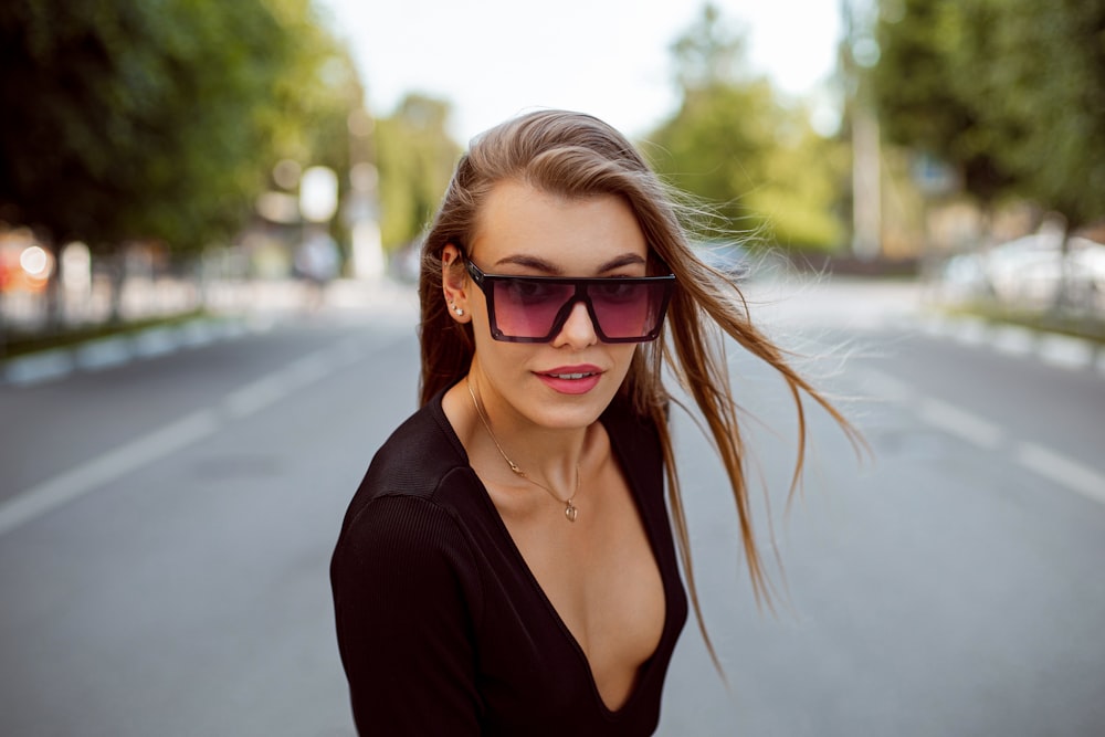 woman in black v neck shirt wearing brown sunglasses