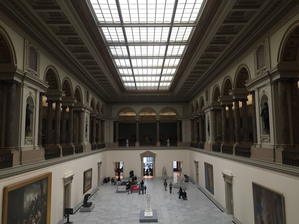 people walking on white and brown building