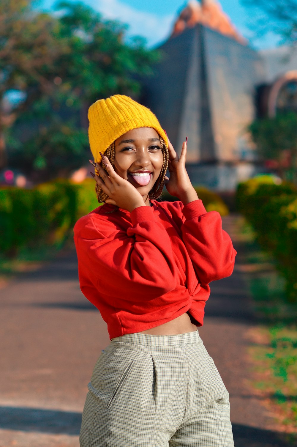 woman in red long sleeve shirt and white skirt