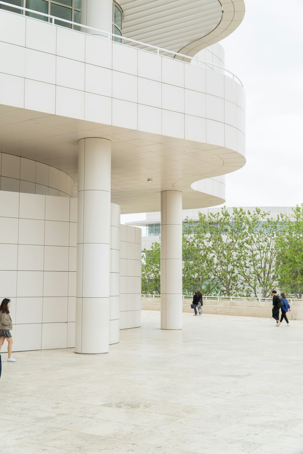 people walking on white concrete building during daytime