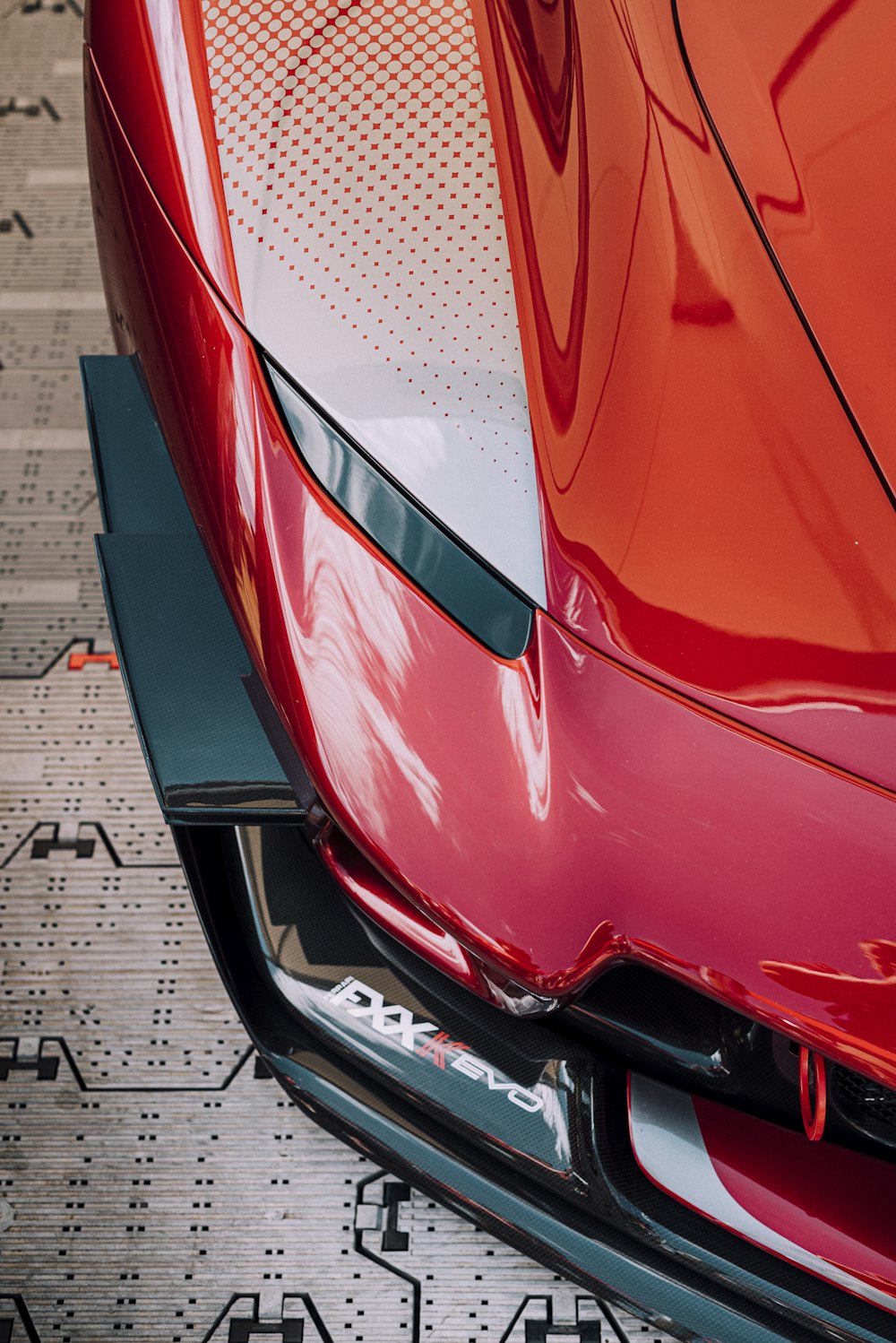 red car on parking lot during daytime