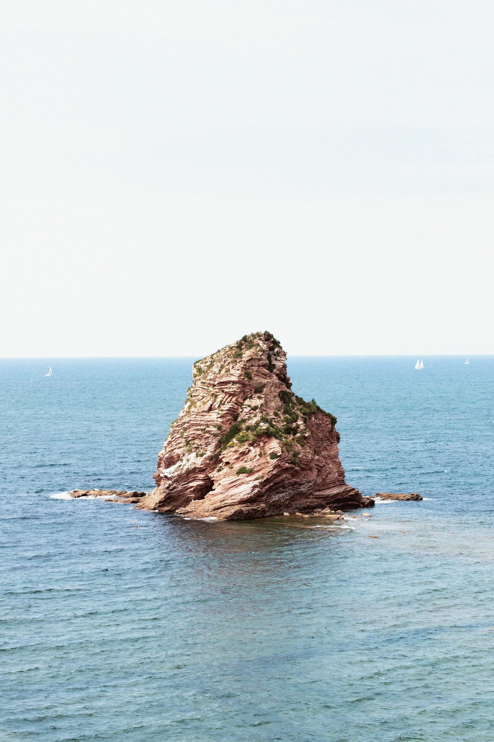 brown rock formation on sea during daytime