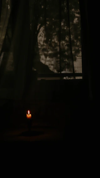 A dimly lit room filled with vintage tarot cards and flickering candles casting dancing shadows.