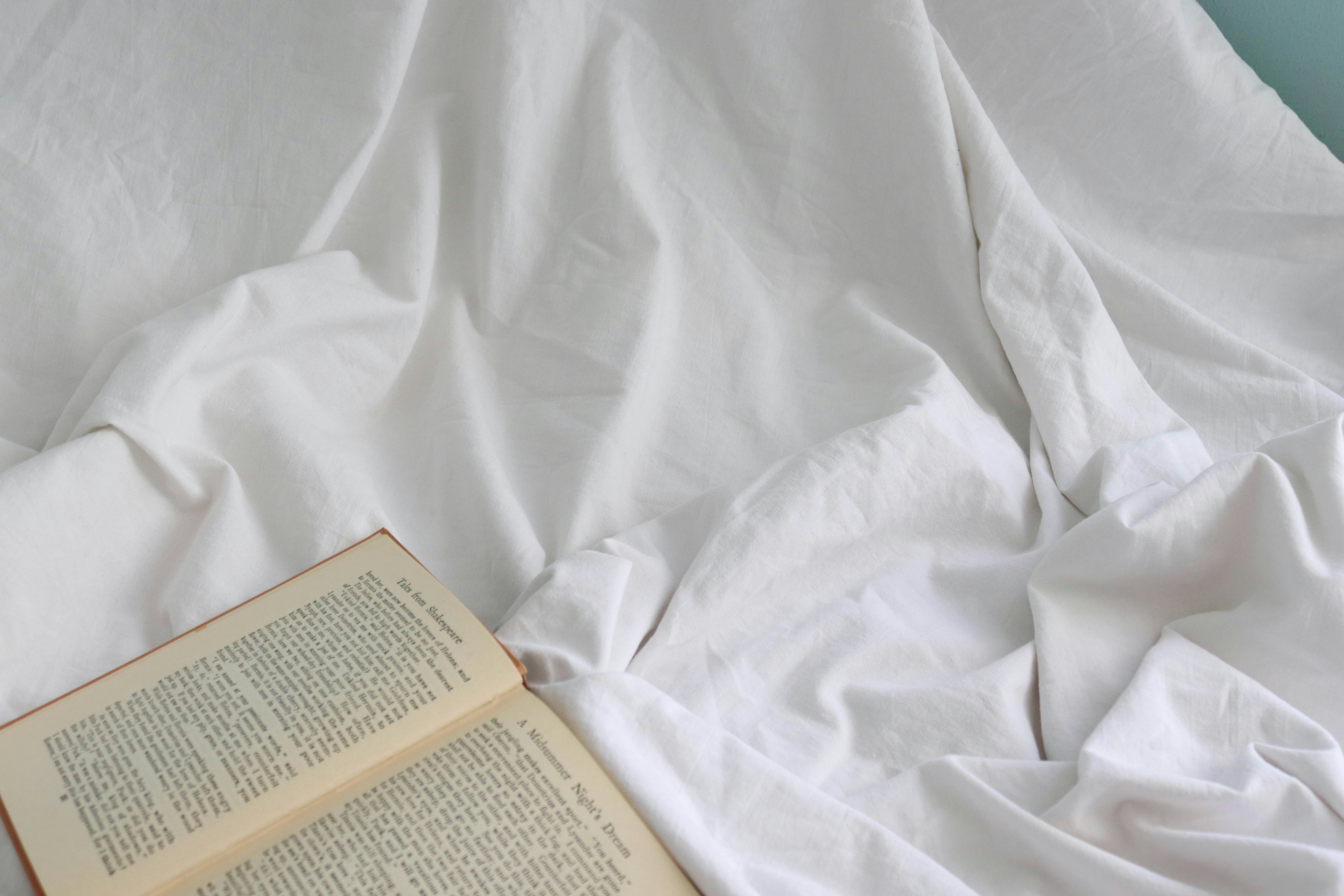 white book on white textile