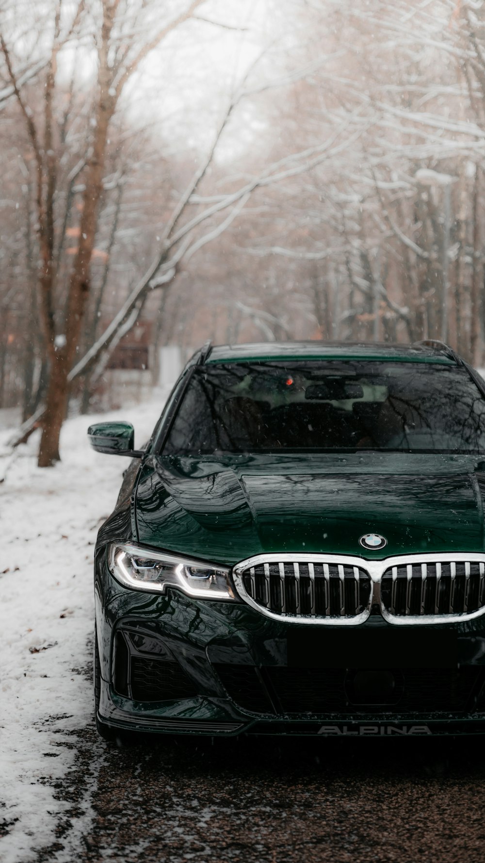 black bmw car on snow covered ground during daytime