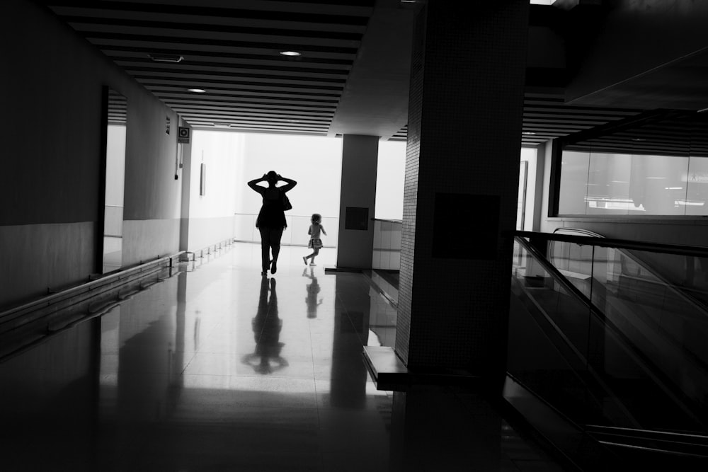 silhouette of woman walking on hallway