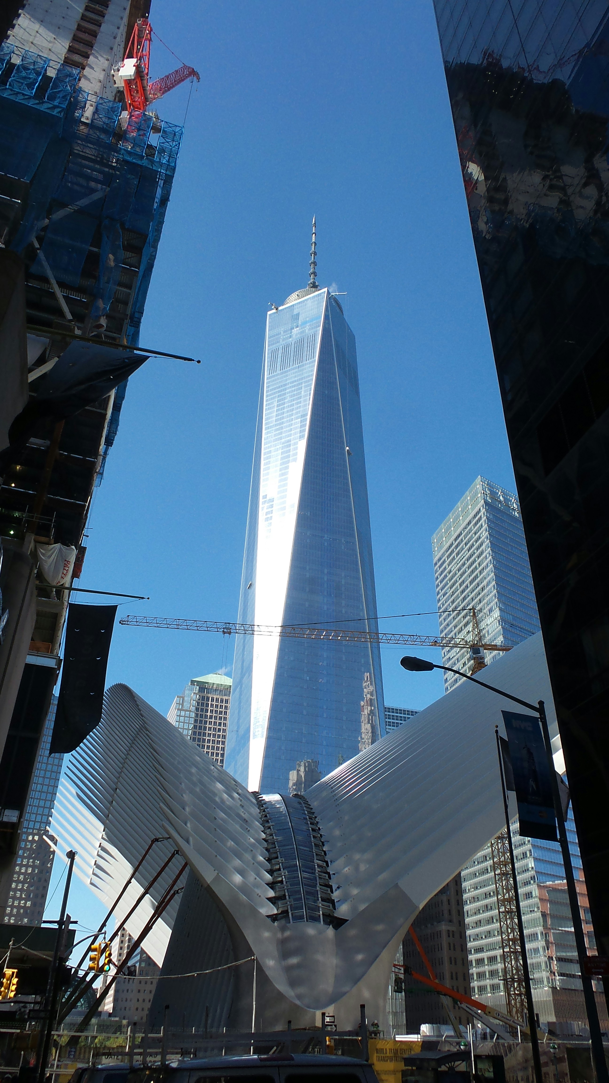 Modern skyscrapers and cranes against a clear blue sky