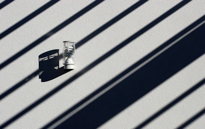 A minimalist wall sconce casting gentle light on a textured wall.