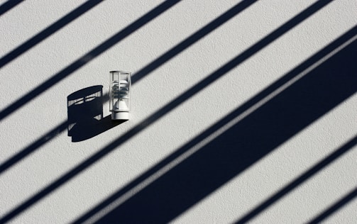 Close-up of a matte black wall sconce highlighting its clean lines and texture.