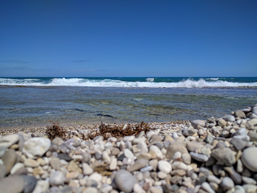 white and brown stones near sea during daytime