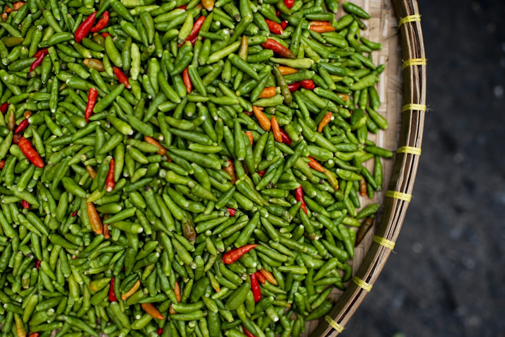 green and red chili on brown woven basket