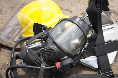 Close-up of various personal protective equipment items such as gloves, helmets, and safety glasses arranged neatly.