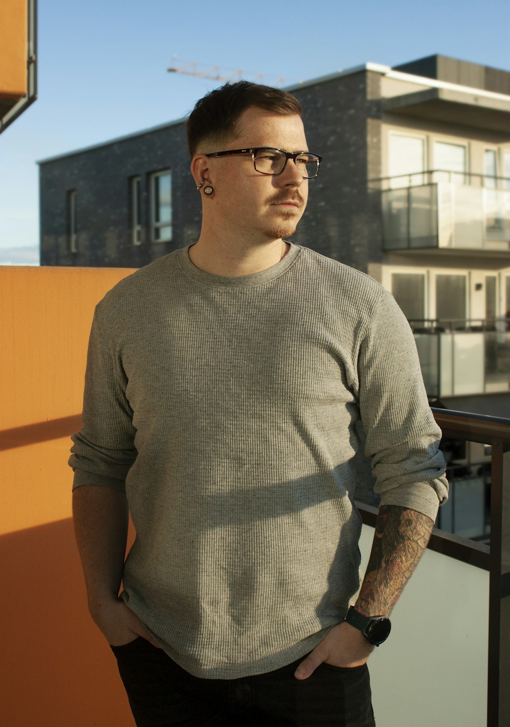 man in gray sweater wearing black framed eyeglasses