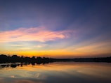 body of water during sunset