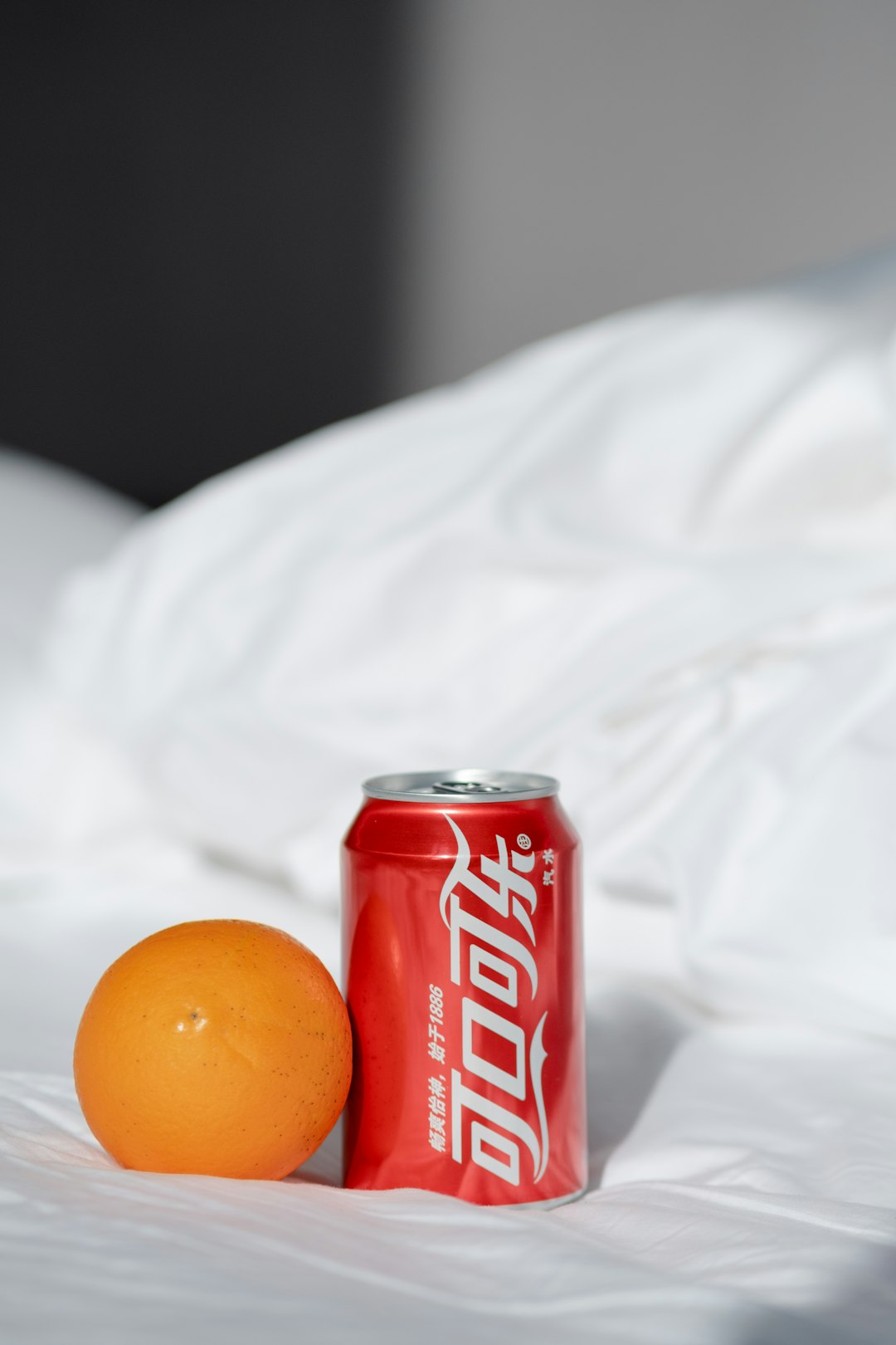 coca cola can on white textile