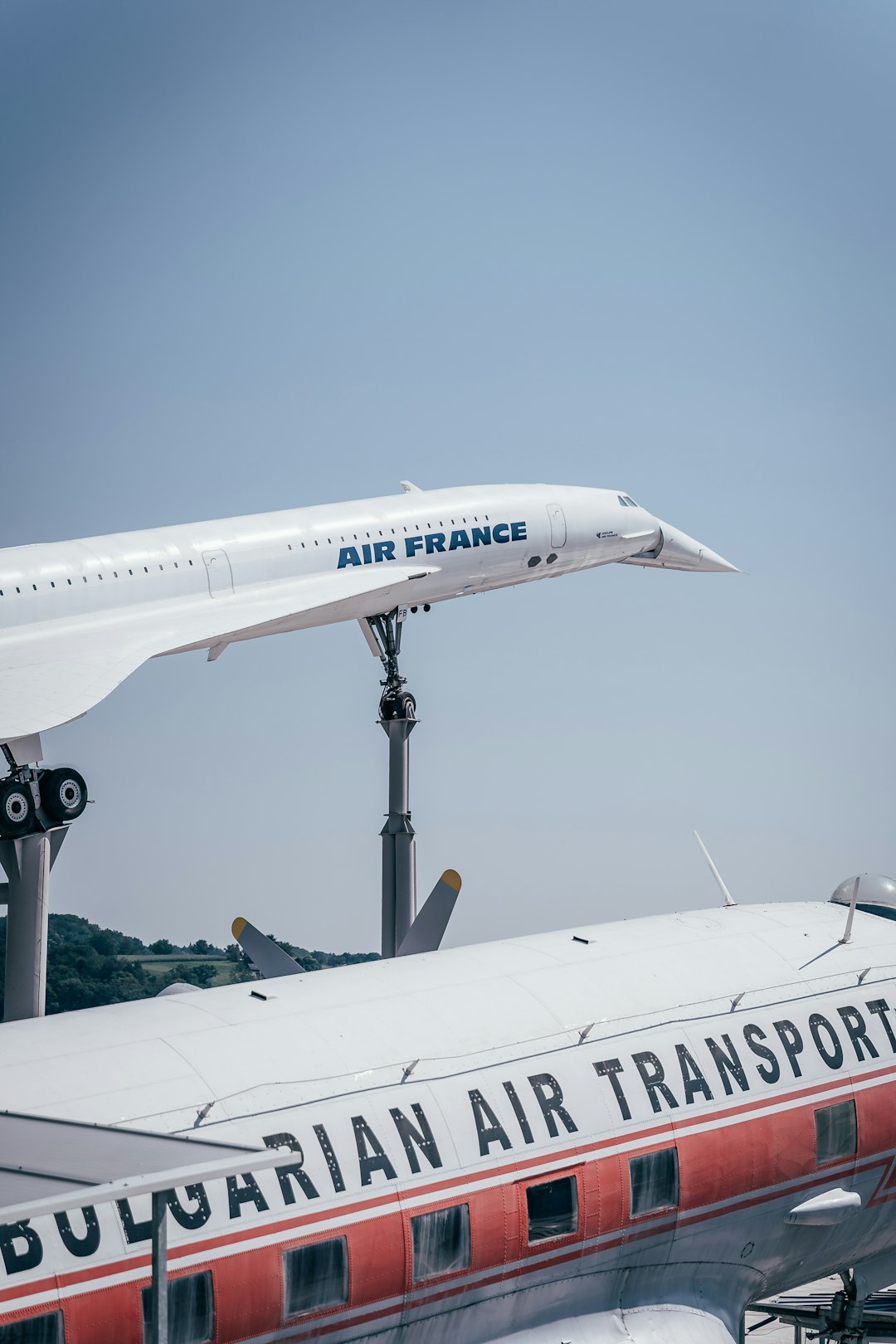 white and blue airplane under blue sky during daytime