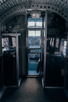 Close-up of a vintage airplane cockpit with dials and controls glowing softly in natural light.