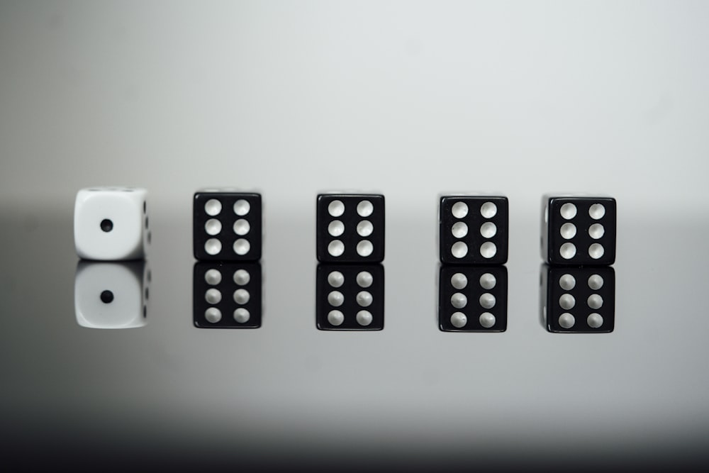 white and black dices on white surface