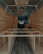 An RV interior featuring newly installed vinyl plank flooring, highlighting a clean and stylish design.