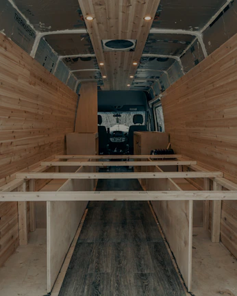 A close-up of a handmade wooden interior detail inside the van, showcasing craftsmanship.