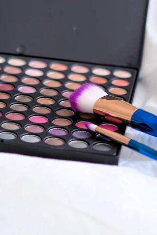 Close-up of a vibrant makeup palette with rich, colorful shades.