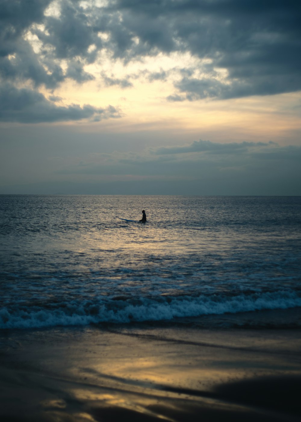 person surfing on sea waves during daytime