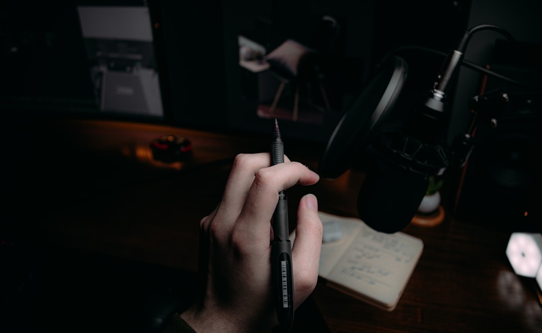 person holding black click pen