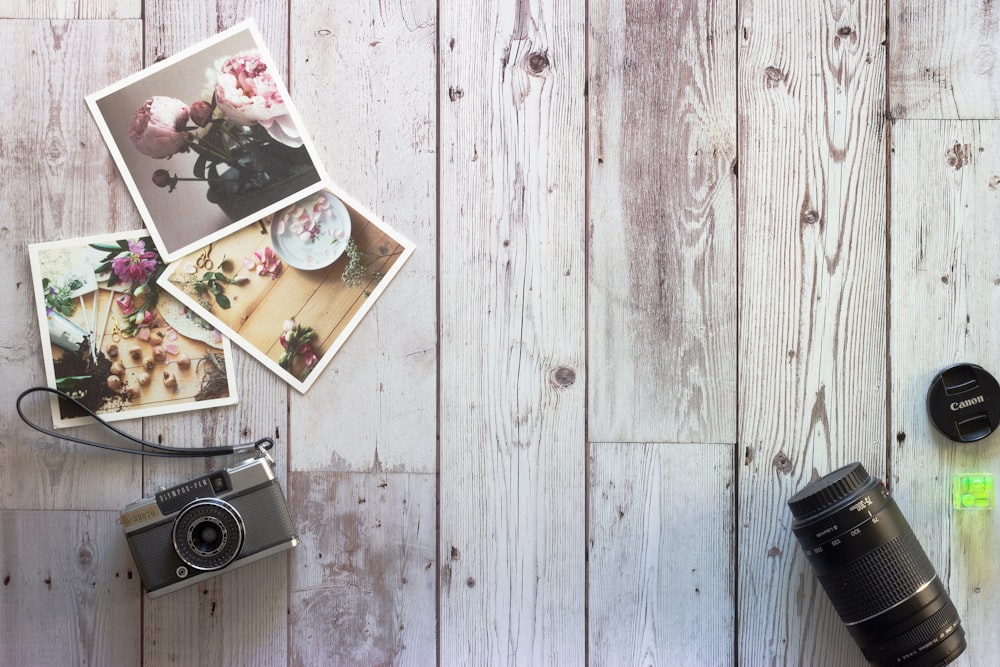 black and silver camera on white wooden table