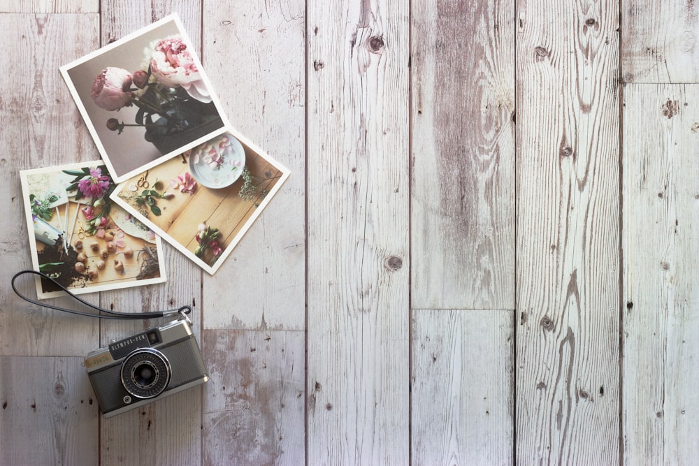 black and silver camera on white wooden table