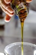person holding clear drinking glass with brown liquid