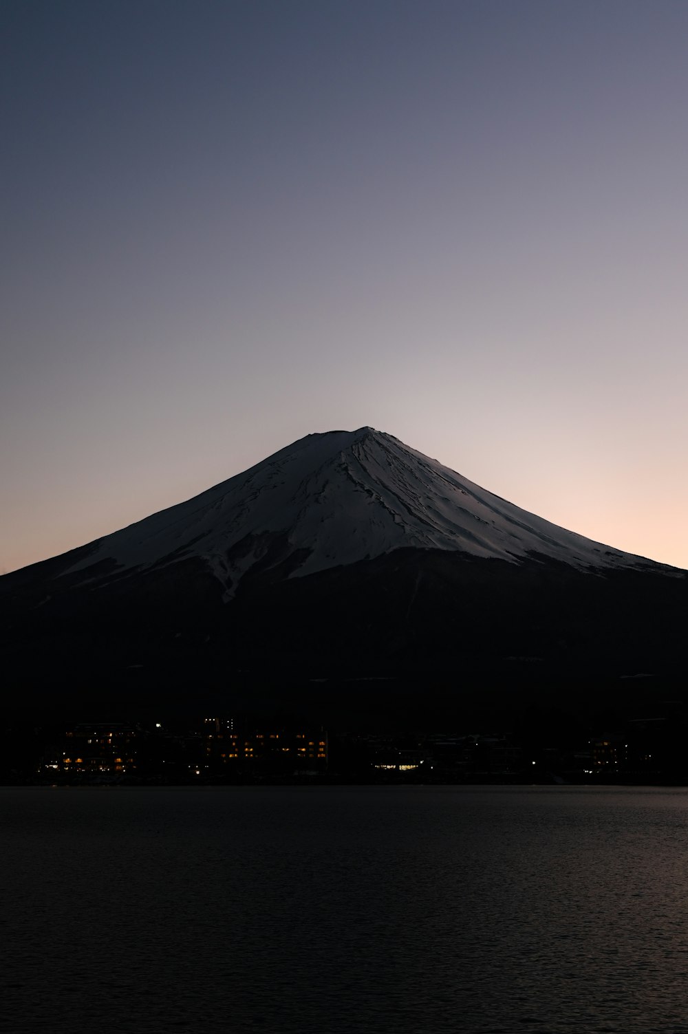 a large mountain with a very tall peak in the distance