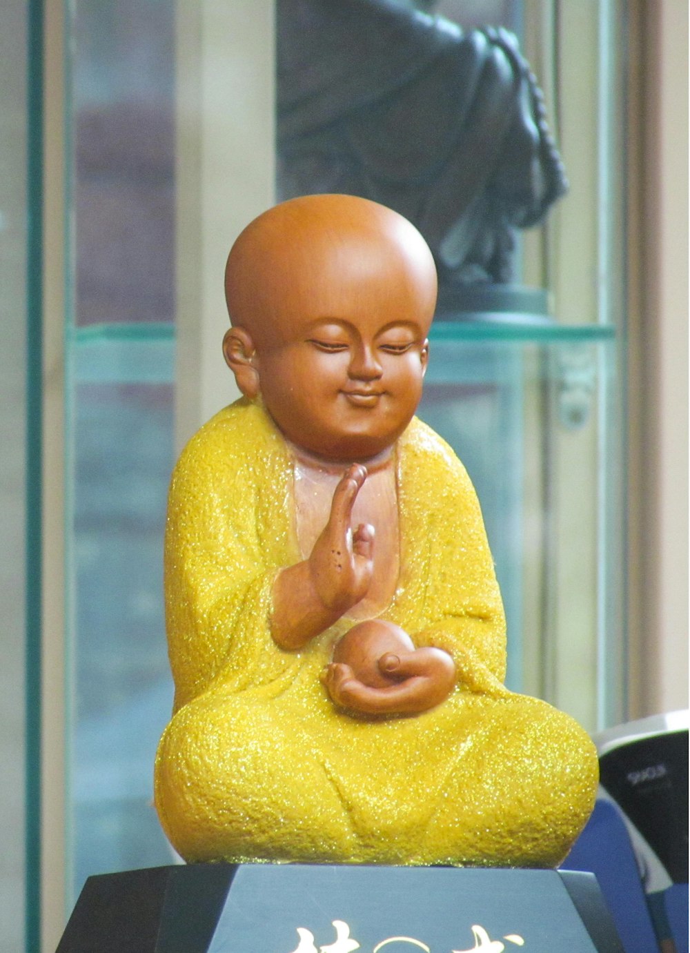 baby in yellow sweater on white table