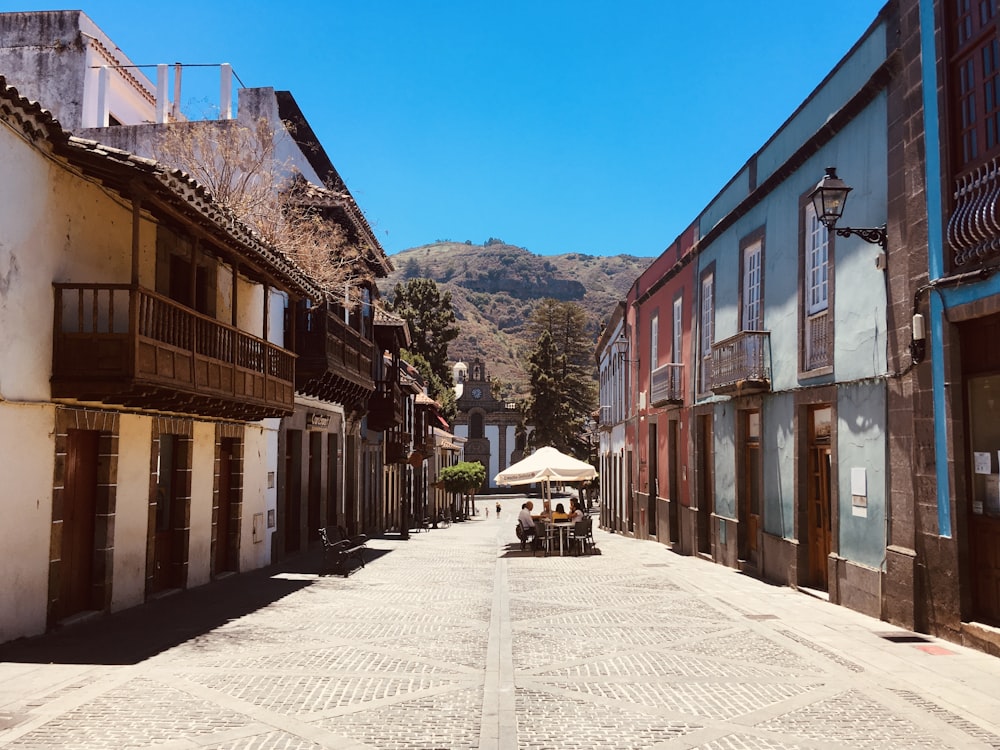 brown wooden houses near mountain under blue sky during daytime