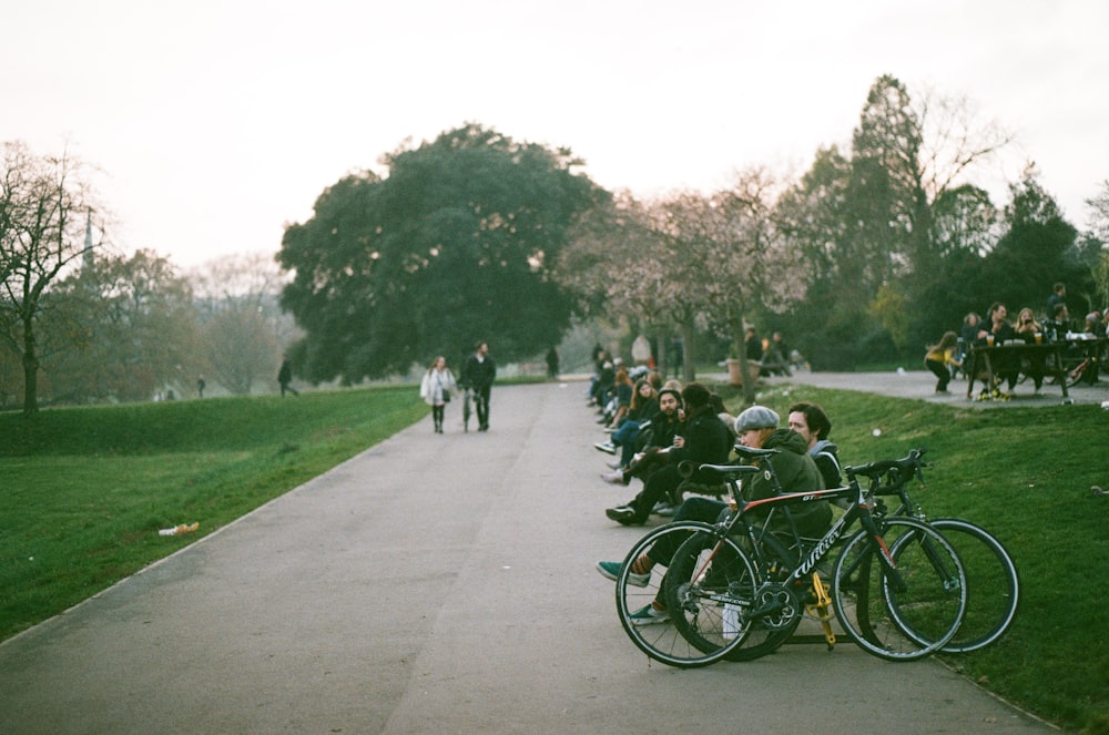 people riding bicycles on road during daytime