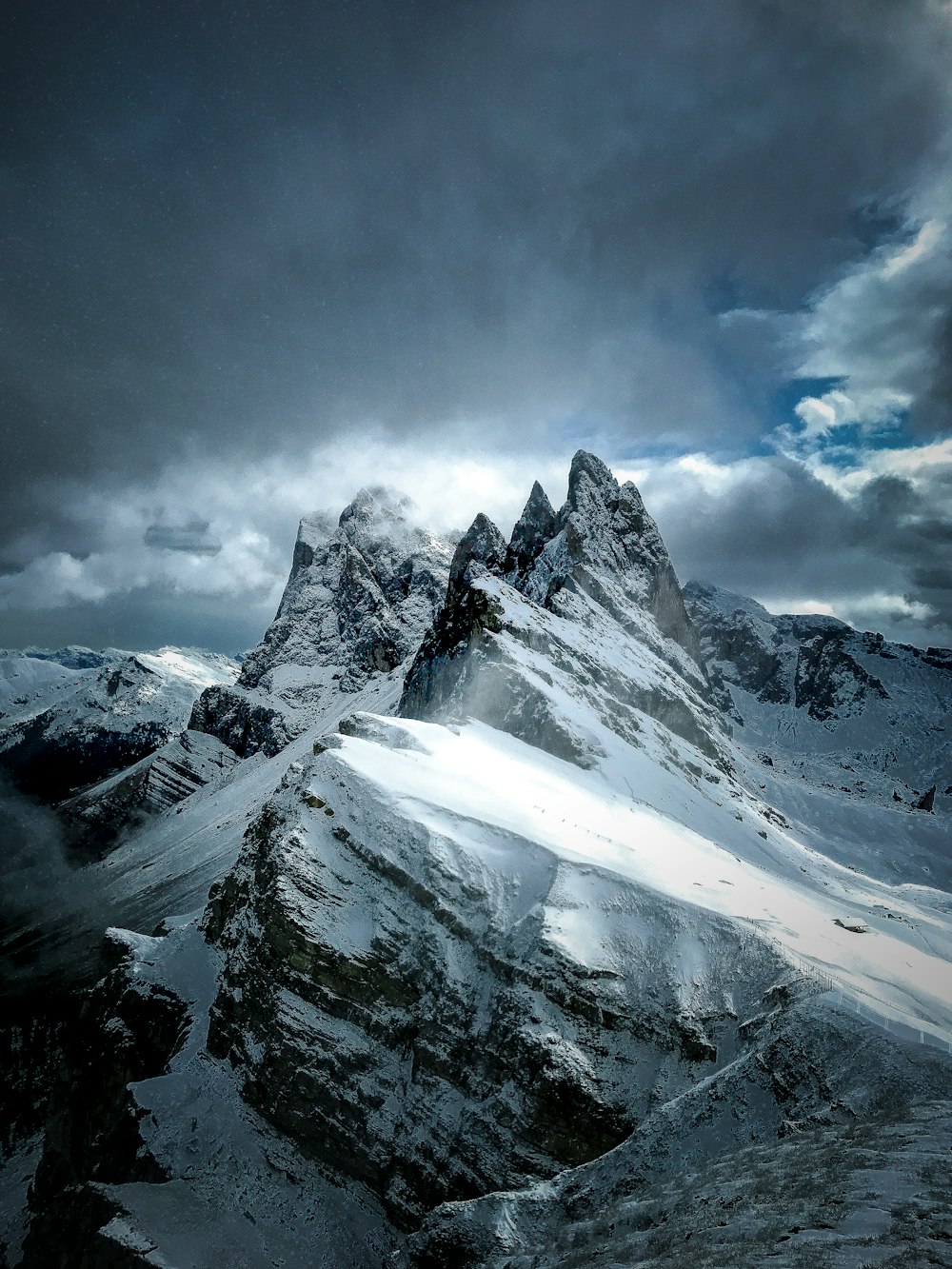 snow covered mountain under cloudy sky during daytime