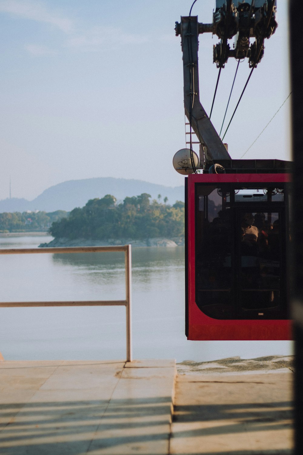 red and black cable car over green grass field during daytime