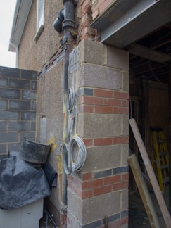 A construction worker examining building materials at a site.
