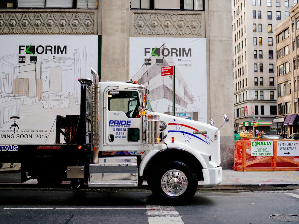 white and blue truck on road during daytime