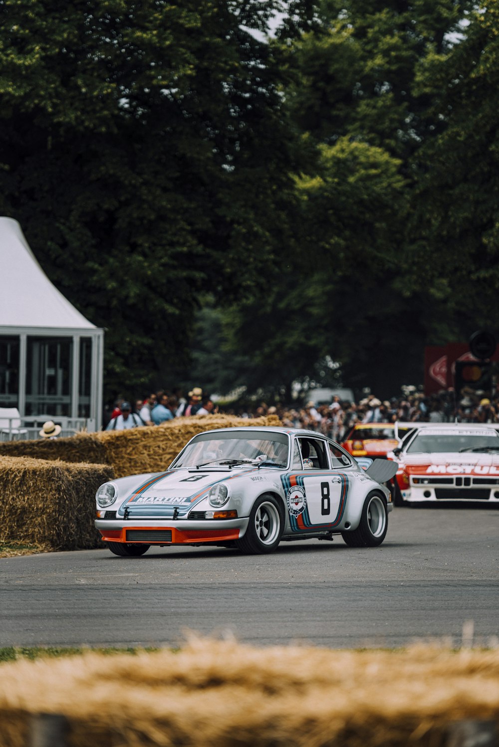 white and red porsche 911 on brown field during daytime