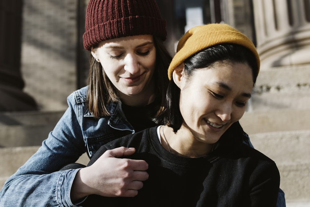 woman in black shirt beside woman in black jacket