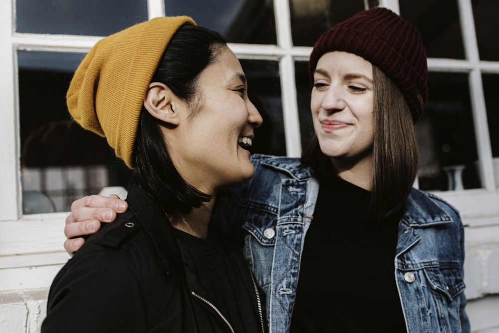 woman in black jacket beside woman in blue denim jacket