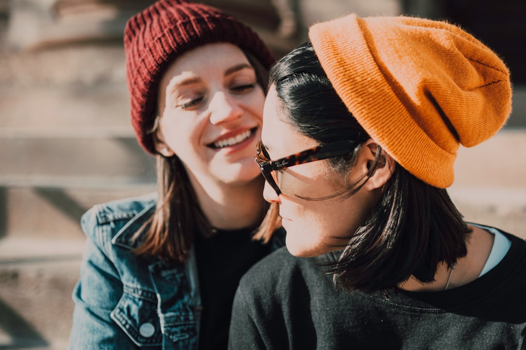 woman in black framed eyeglasses and orange knit cap