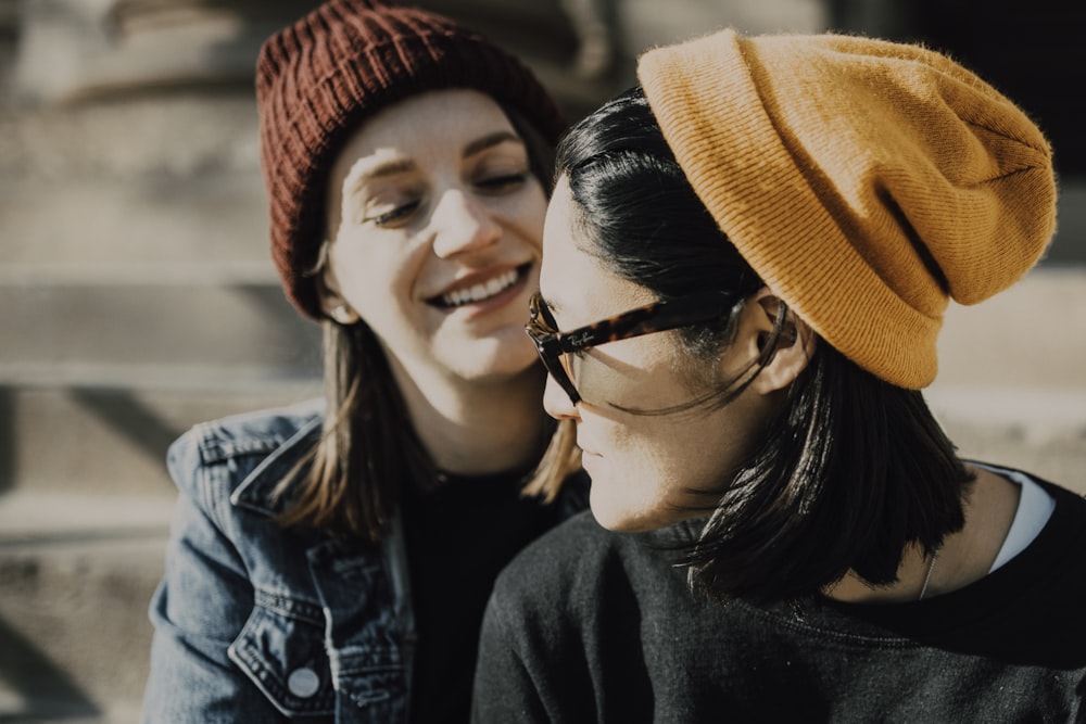 Mujer con gafas de montura negra y gorro de punto naranja