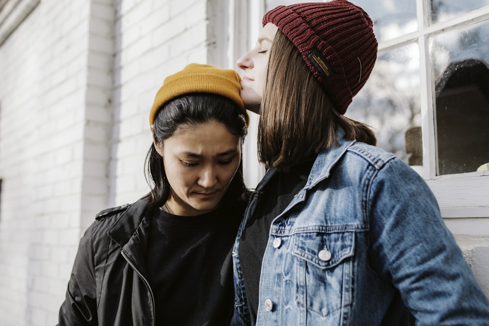 girl in black leather jacket and red knit cap