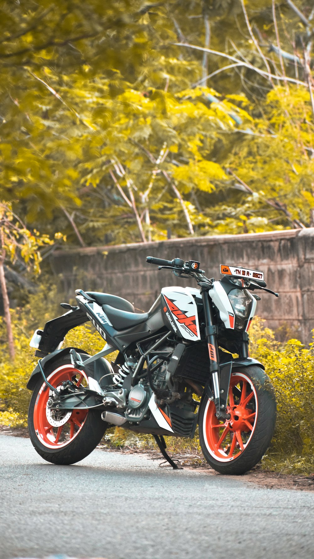 black and white sports bike parked on gray concrete pavement during daytime