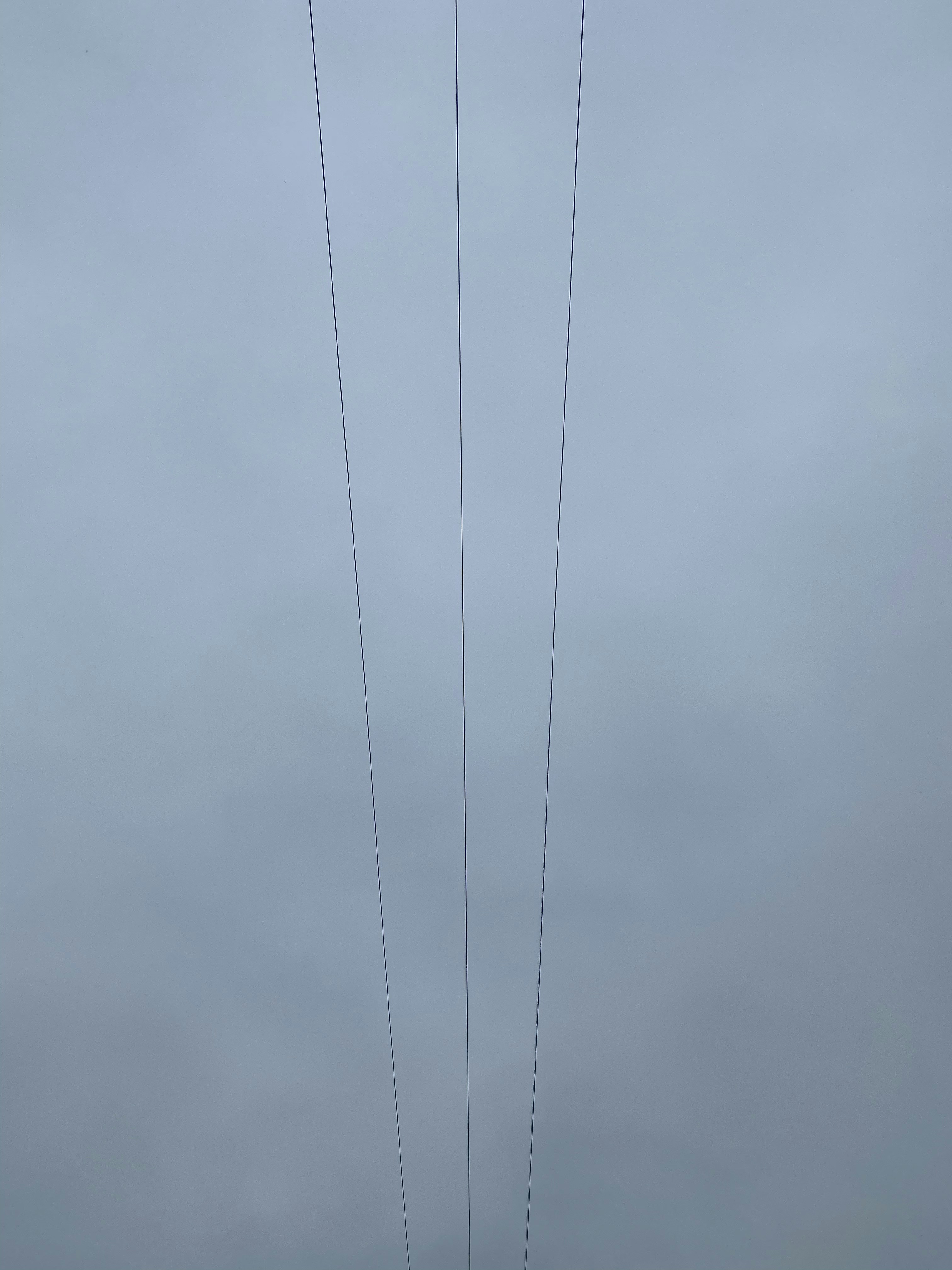 black coated wire under gray clouds