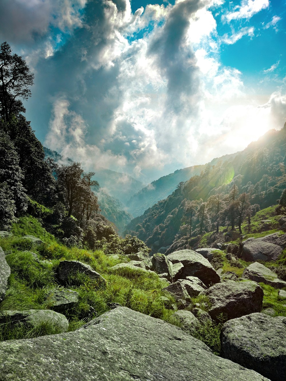 green and gray mountains under white clouds and blue sky during daytime